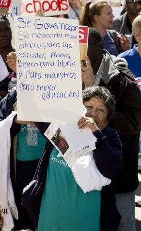Woman at the Save Texas Schools Rally holds up her sign. Translated from Spanish: "Mr. Governor/we need more/ money for the schools Now/Money for books/and For teachers/for better education!"