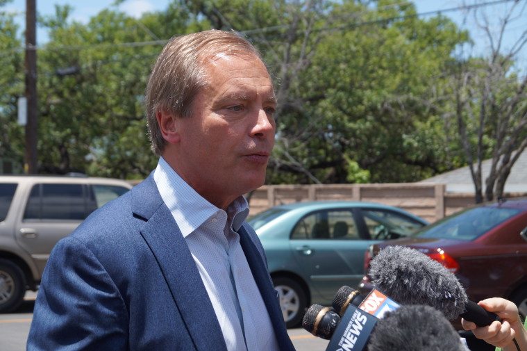 Lt. Gov. David Dewhurst speaks to reports on the first day of early voting. May 19, 2014.