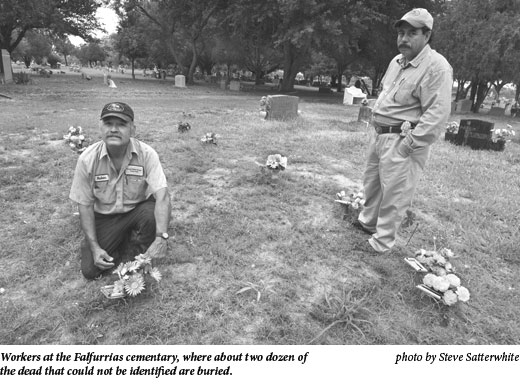 Workers at the Falfurrias cemetary, where about two dozen of the dead that coulud not be identified are buried.
