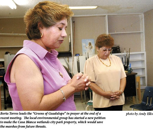 Berta Torres leads the 'Greens of Guadalupe' in prayer at the end of a recent meeting. The local environmental group has started a new petition to make the Casa Blanca wetlands city park property, which would save the marshes from future threats.