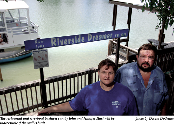The restaurant and riverboat business run by John and Jennifer Hart will be inaccessible if the wall is built.