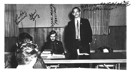 surveillance photo of 3 men with writing all over it