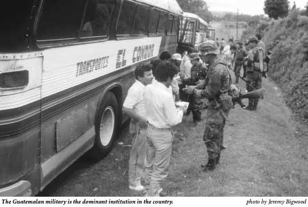 Guatemalan soldiers questioning passengers on a bus