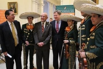 Rep. Bobby Guerra and Rep. Dan Branch pose for a photo-op with a few members of Mariachi Azatlan.