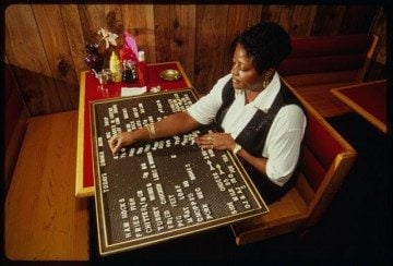 Restaurant worker Gladys Prior arranges a menu board at E & A Soul Food Restaurant, 82 Straight Street, Paterson, New Jersey on September 15, 1994.