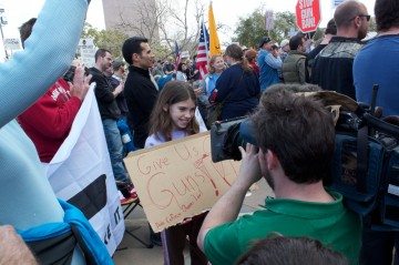 A girl holds a pro-gun sign at the Guns Across America rally in Austin.