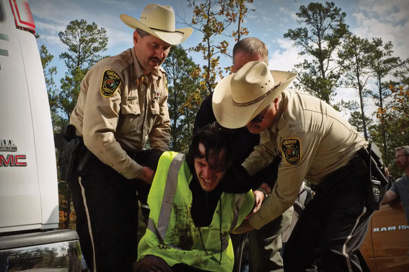 A blockader is detained after being pepper-sprayed by Cherokee County deputies.