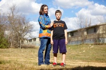 Edy Chamness and her son Christopher on the path behind his elementary school in far South Austin.
