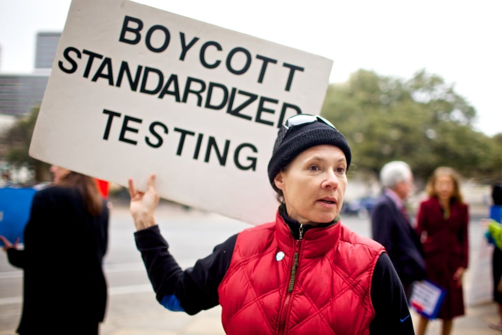 Alongside other test reform demonstrators outside the State Capitol, Chamness carries the only sign urging all-out boycott.