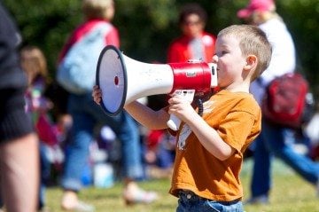 A boy yells, "Save our schools!" through a megaphone at the Save Texas Schools rally.
