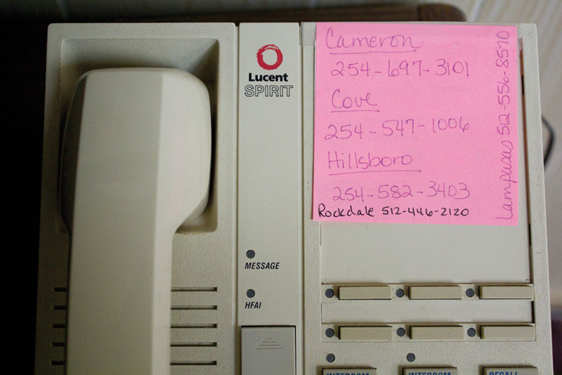 Office items like this phone remain in what was once the administrative office in San Saba. The clinics listed have also closed.