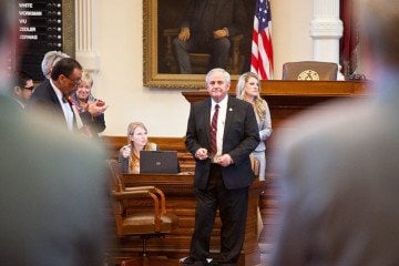House members stand to applaud Rep. Jimmie Don Aycock (R-Killeen) after hours of debate on his omnibus school bill House Bill 5.
