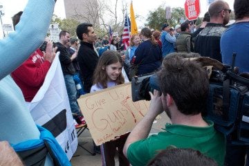 A girl holds a pro-gun sign at the Guns Across America rally in Austin, Texas, January 19, 2013.
