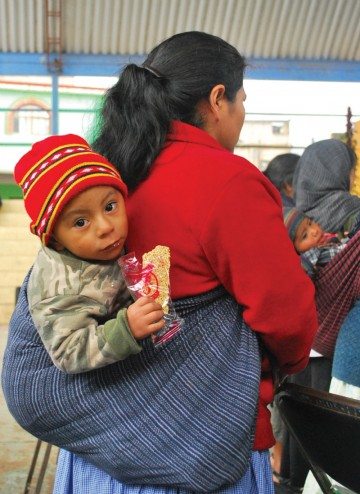 Maria Abdiel with her child at a cooking workshop, Tlahuitoltepec.