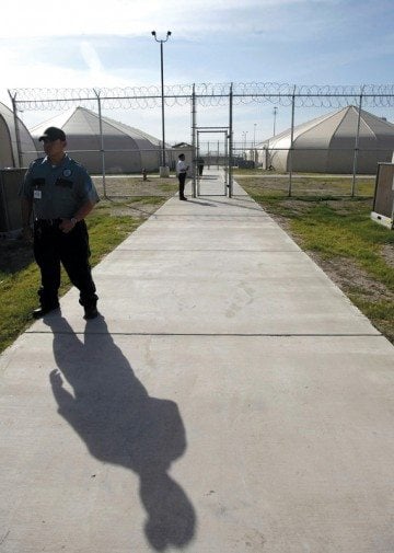 Security guards patrol the area of the Willacy County Detention Center for Immigrant detainees in Raymondville, Texas. 