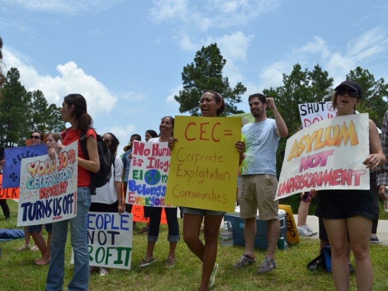 Activists chant outside the Polk County Detention Center