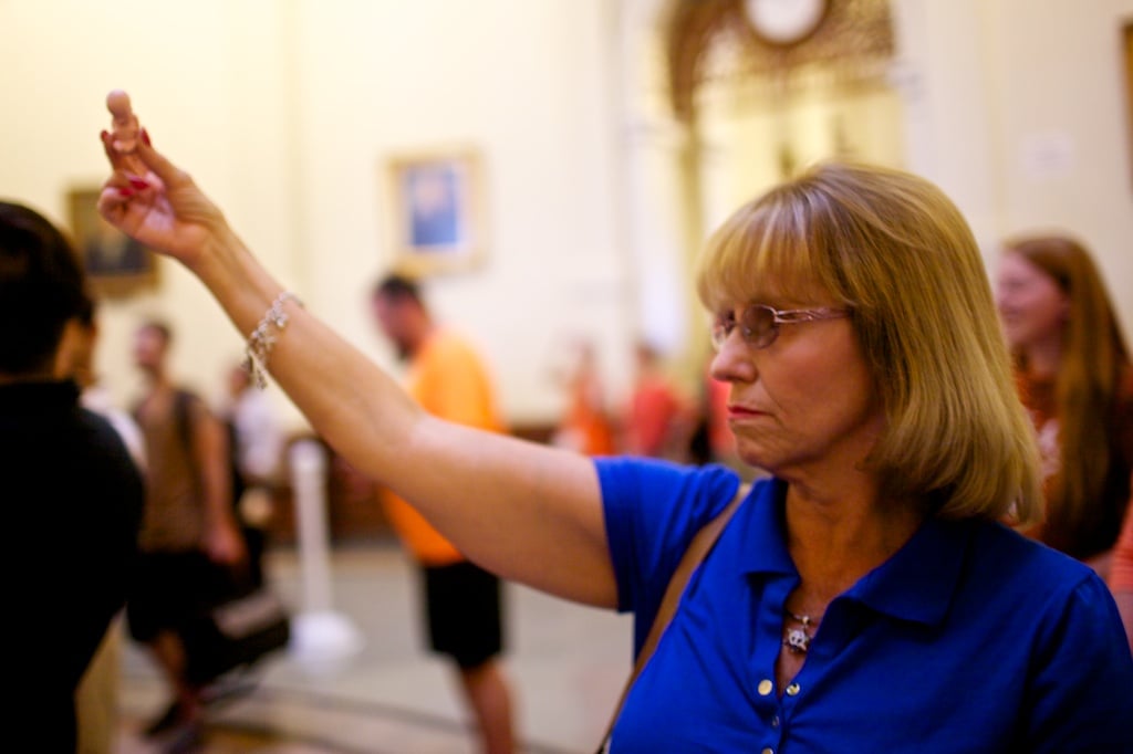 A woman holds up a plastic baby as pro-choice demonstrators chant in the Capitol rotunda.