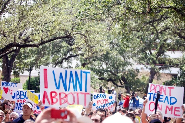 Abbott fans wave hand-made signs of almost uniform quality and style.