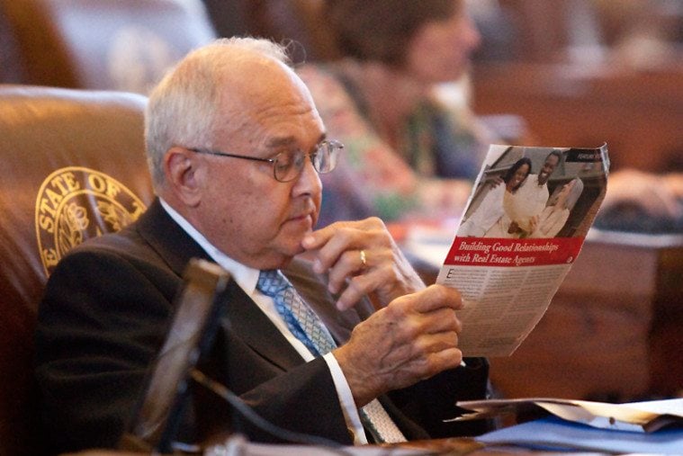 Rep. Bill Callegari peruses some reading material on real estate during Turner's speech.