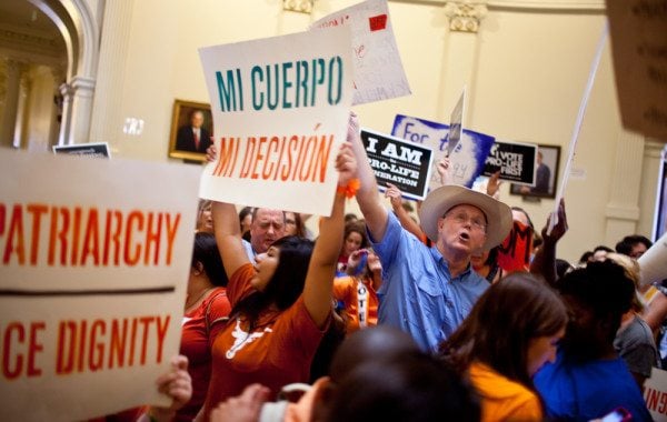 Activists chant and yell in the Capitol rotunda as the House debates new abortion restrictions.