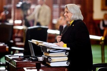 Sen. Judith Zaffirini (D-Laredo) begins questioning House Bill 2 sponsor Glenn Hegar (R-Katy), armed with binders of material for the debate.