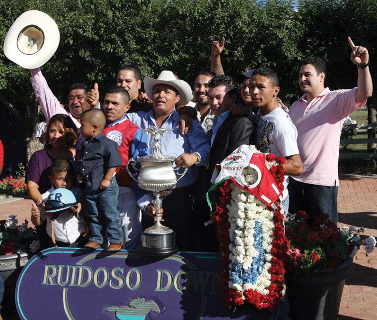 Jose Trevino Morales, center, acknowledges the crowd after his horse, Mr. Piloto, won the All-American Futurity race at Ruidoso Downs, New Mexico, in September 2010.