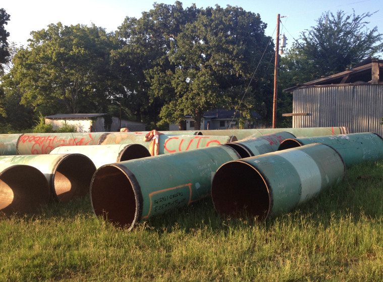 Pipe cutouts are piled near Rusk.