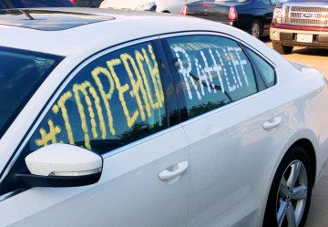 A car with "Impeach Ratliff" written on the windows.