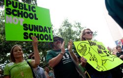 Signs at the Texas Freedom Network's Stand Up for Science rally