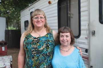 Roxanne Joganik, left, and Darlina
Anthony outside their RV in Seven Points, where they moved after being
evicted from a park in Athens.