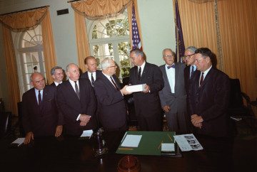 Members of the Warren Commission present their report on the assassination of President John F. Kennedy to President Lyndon Johnson in the White House Cabinet Room, Washington, D.C.
