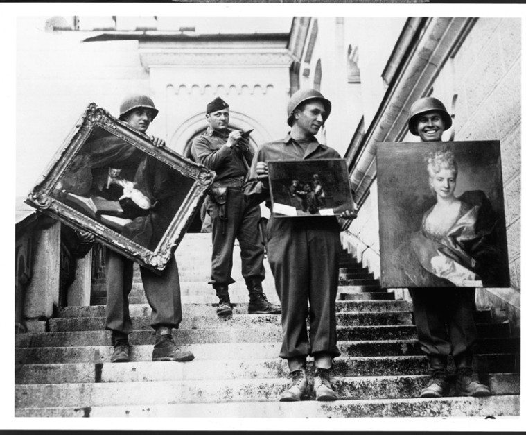 Monuments Man James Rorimer, who would become Director of the Metropolitan Museum of Art following World War II, is seen standing, at top, in the castle of Neuschwanstein. He is supervising the recovery of looted paintings.