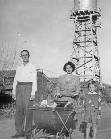 Mr. and Mrs. Werner Ulrich, Sr. and children walking down a street at the Crystal City Internment Camp, 1946.