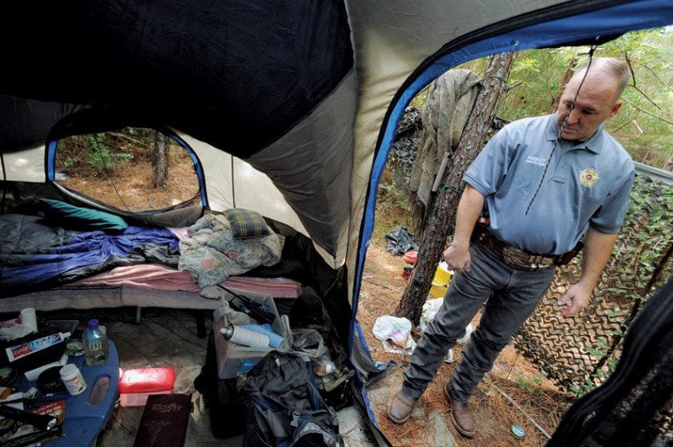 Nacogdoches County Sheriff Jason Bridges inspects Holliman’s camp in the woods.