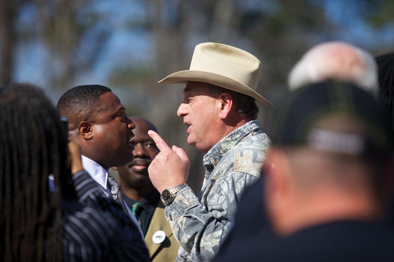 Quanell X confronts Nathan Ener in a charged moment during the protest in Hemphill.