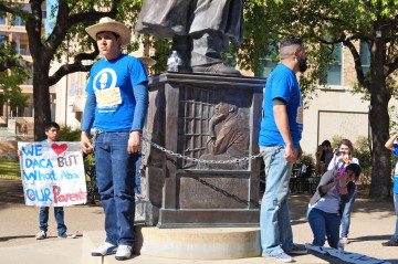 Anti-Deportation protestors chain themselves to UT's MLK statue on the second day of the Civil Rights Summit. April 9, 2014.