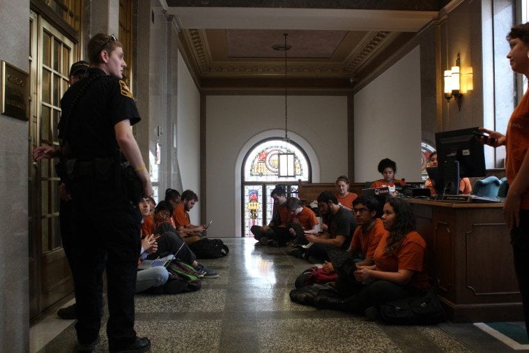 UT-Austin students stage a sit-in to protest a job-elimination plan.