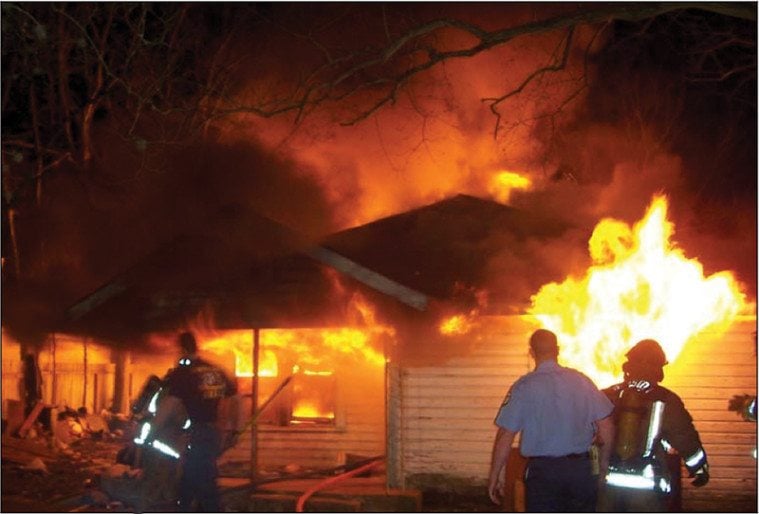 Houston firefighters wait for their colleagues to escape the blaze after the roof collapsed.