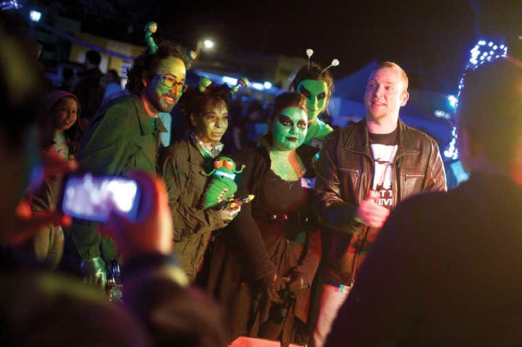 Del Rio doctor Aurelio Laing, left, being interviewed with his wife, Stormy Laing, after winning the Del Rio UFO Festival costume contest. 