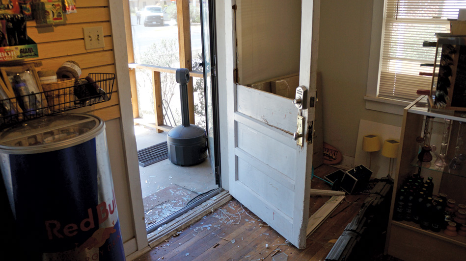 The Purple Zone's wrecked front door following the federal raid in May.
