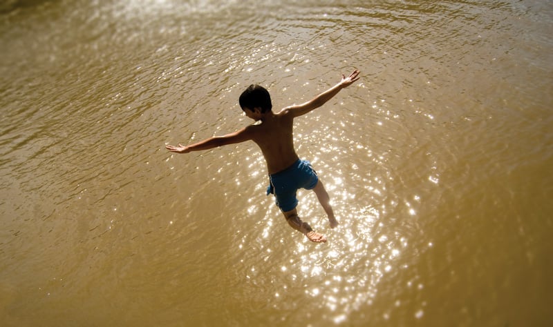 Taking flight at a Sabine River swimming hole.