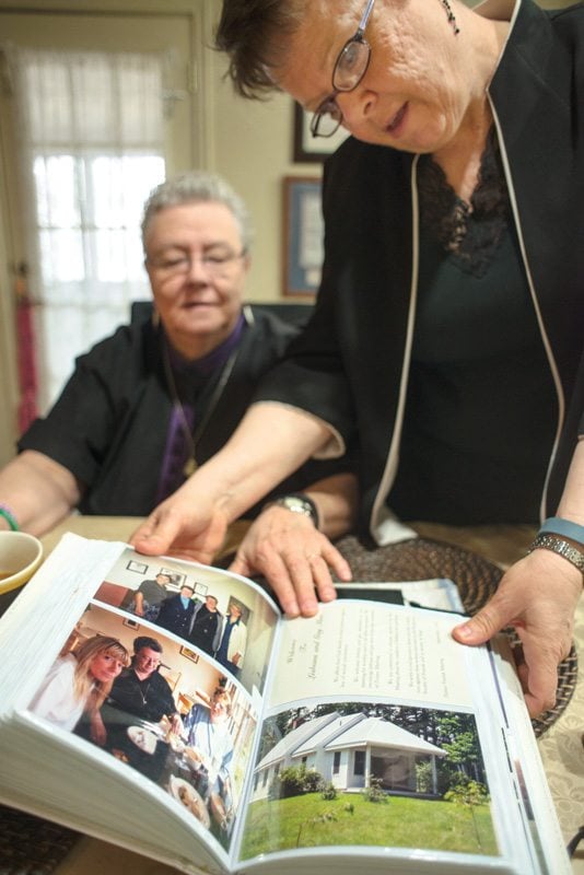 Reverend Margaret Walker and Monica Warn with pictures of their civil union ceremony in Vermont