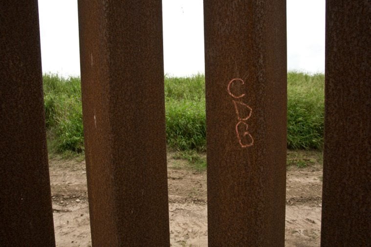 Graffiti on the border wall, which members of Camp Lonestar believe to be the initials for Cartel de Golfo. 