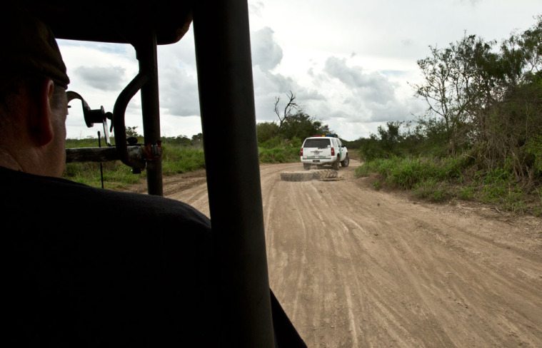 A border patrol SUV drags tires to erase old footprints and allow law enforcement to monitor recent crossings.