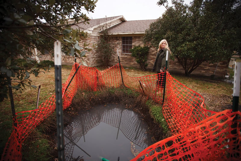 Lori Collins in front of her house.