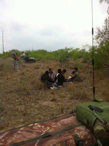 A group of immigrants, with hands bound and shows removed, detained by the Texas Border Volunteers in April 2013.
