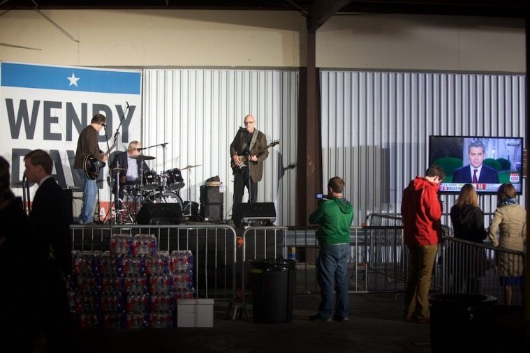 Arlington's BlueBeats warm up onstage while the crowd slowly freezes.