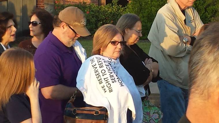 A woman waits in line outside the "I Stand Sunday" rally in Houston. 