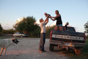 Amber and Fred Lyssy and their young children mixed family time with chores at their 564-acre organic farm in Wilson County.