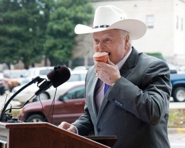 Texas Agriculture Commissioner Sid Miller bites into a cupcake during a January press conference in Austin.